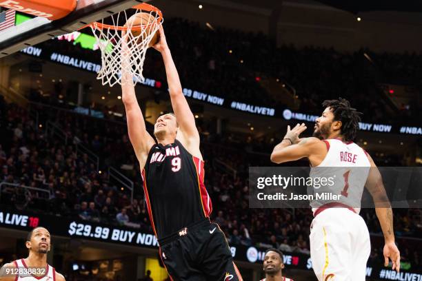 Kelly Olynyk of the Miami Heat dunks over Derrick Rose of the Cleveland Cavaliers during the first half at Quicken Loans Arena on January 31, 2018 in...