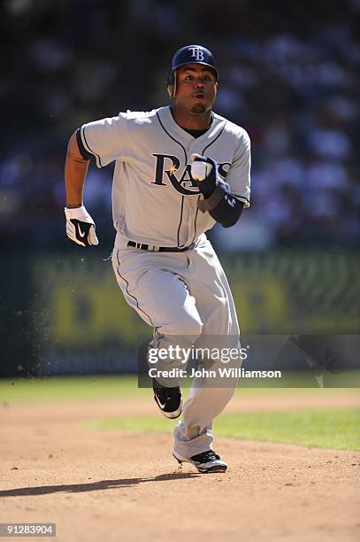 Carl Crawford#13 of the Tampa Bay Rays runs and advances safely to third base after he tagged up at second base on a fly ball to the outfield during...