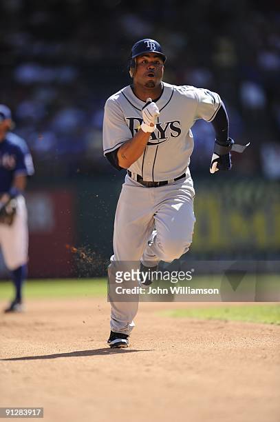 Carl Crawford#13 of the Tampa Bay Rays runs and advances safely to third base after he tagged up at second base on a fly ball to the outfield during...