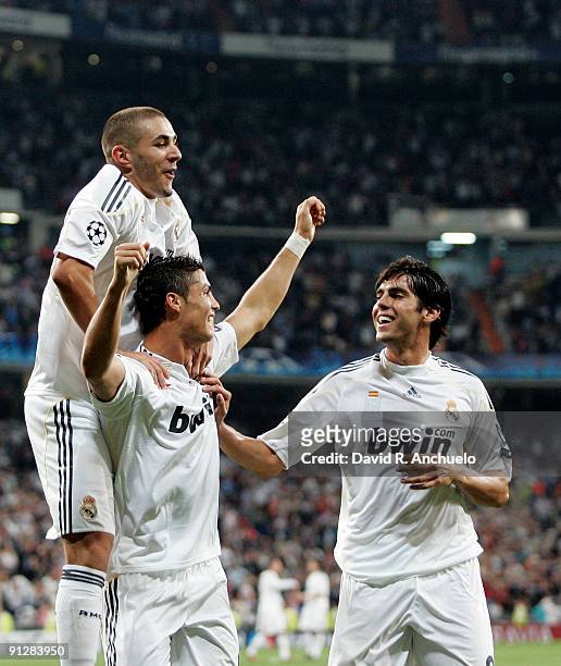 Cristiano Ronaldo of Real Madrid celebrates with his team mates Karim Benzema and Kaka during the UEFA Champions League Group C match between Real...