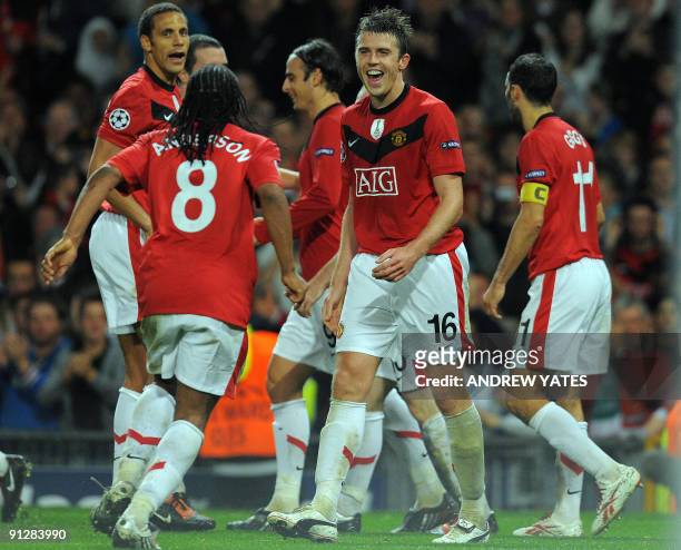 Manchester United's English midfielder Michael Carrick celebrates scoring against VfL Wolfsburg during their UEFA Champions League Group B football...