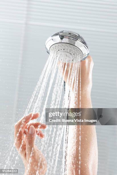 woman taking shower, hands on shower head. - shower head stock pictures, royalty-free photos & images