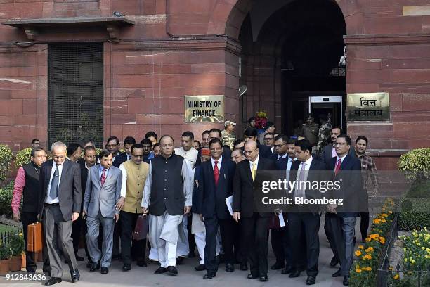 Arun Jaitley, India's finance minister, center left, and other members of the finance ministry depart the North Block of the Central Secretariat...