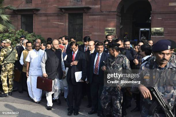 Arun Jaitley, India's finance minister, front second left, and other members of the finance ministry depart the North Block of the Central...