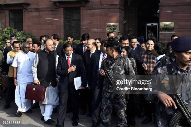 Arun Jaitley, India's finance minister, front second left, and other members of the finance ministry depart the North Block of the Central...