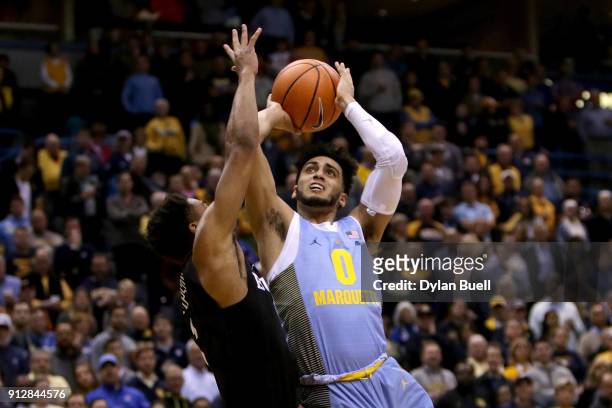 Markus Howard of the Marquette Golden Eagles attempts a shot while being guarded by Aaron Thompson of the Butler Bulldogs in the first half at the...