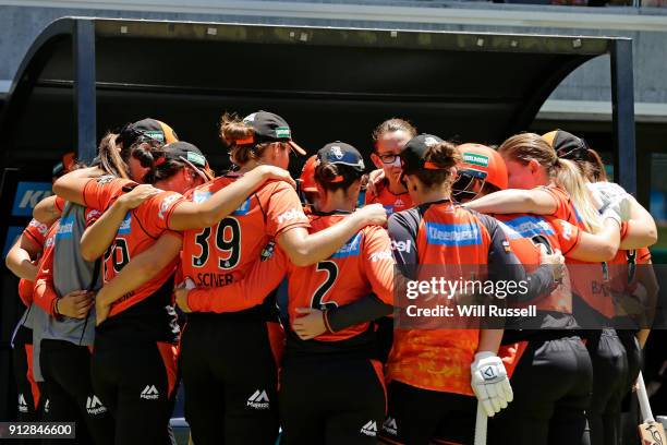 The Scorchers form a huddle during the Women's Big Bash League match between the Sydney Thunder and the Perth Scorchers at Optus Stadium on February...