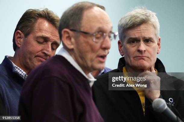 Sens. Jeff Flake and Bill Cassidy listen to Rep. Phil Roe speak during a news briefing to discuss the train accident while they were on their way to...