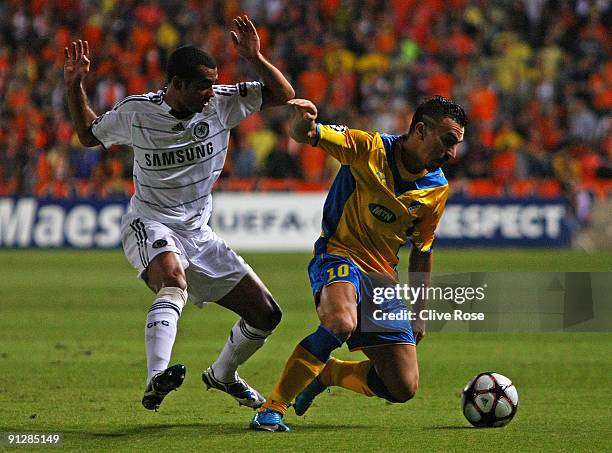 Costas Charalambides of APOEL battles with Ashley Cole of Chelsea during the UEFA Champions League Group D match between Apoel Nicosia and Chelsea at...