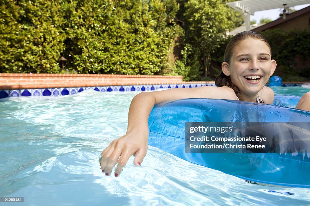 Tween Floating Inpool Young Girl In Pool Floating In An Inflatable Tube High-Res Stock Photo ...