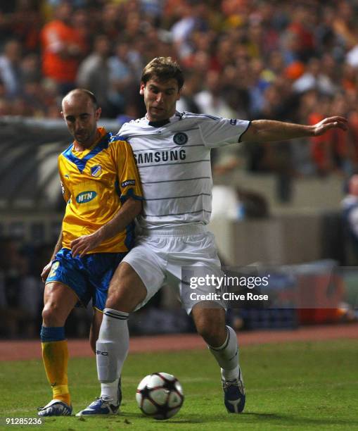 Altin Haxhi of APOEL battles with Branislav Ivanovic of Chelsea during the UEFA Champions League Group D match between Apoel Nicosia and Chelsea at...