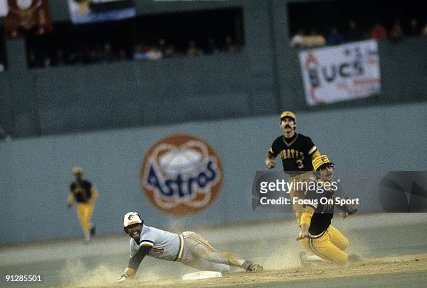 Shortstop Tim Foli of the Pittsburgh Pirates gets his throw off to first avoiding the slide of Baltimore Orioles Al Bumbry during a 1979 world series...