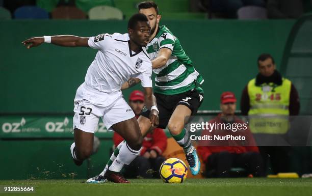 Guimaraes's defender Ghislain Konan vies with Sporting's midfielder Bruno Fernandes during the Portuguese League football match between Sporting CP...