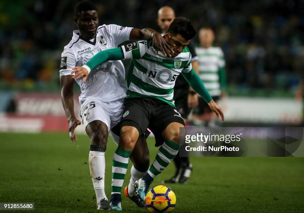 Guimaraes's midfielder Wakaso vies with Sporting's midfielder Marcos Acuna during the Portuguese League football match between Sporting CP and...