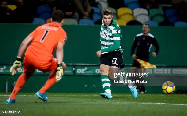 Sporting's defender Stefan Ristovski vies with Guimaraes's goalkeeper Douglas Jesus during the Portuguese League football match between Sporting CP...