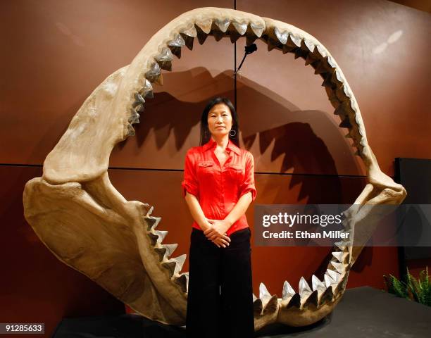 Enya Kim from the Natural History department at auctioneers Bonhams & Butterfields stands in front of one of the world's largest set of shark jaws...