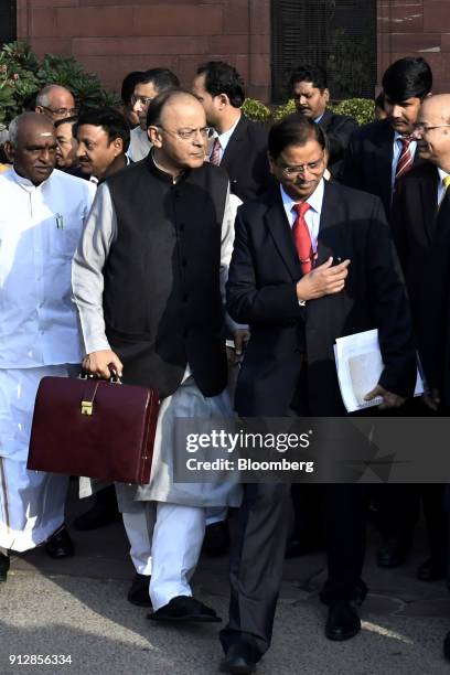 Arun Jaitley, India's finance minister, center left, and other members of the finance ministry depart the North Block of the Central Secretariat...