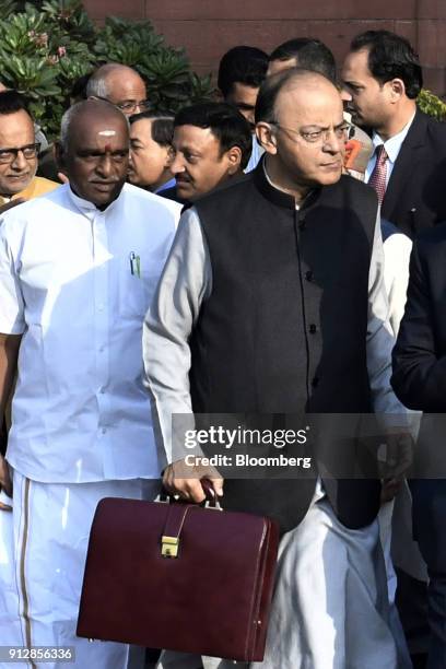 Arun Jaitley, India's finance minister, right, and other members of the finance ministry depart the North Block of the Central Secretariat building...