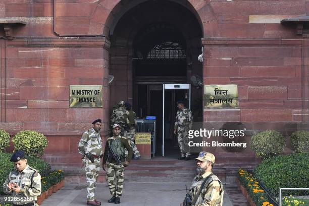 Security personnel stand outside an entrance to the North Block of the Central Secretariat building before India's finance minister Arun Jaitley...