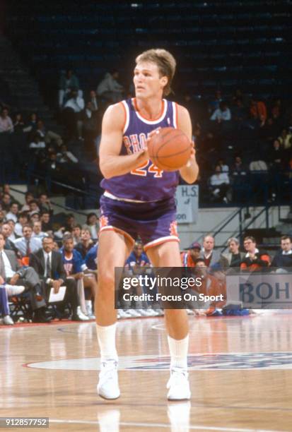 Tom Chambers of the Phoenix Suns looks to shoot against the Washington Bullets during an NBA basketball game circa 1990 at the Capital Centre in...