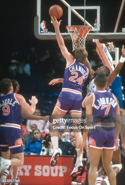 Tom Chambers of the Phoenix Suns shoots over Harvey Grant of the Washington Bullets during an NBA basketball game circa 1990 at the Capital Centre in...