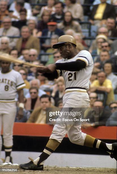 Outfielder Roberto Clemente of the Pittsburgh Pirtates swings and watches the flight of his ball against the Baltimore Orioles during the World...