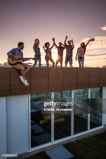 guitar party on a penthouse rooftop! - penthouses party stock pictures, royalty-free photos & images