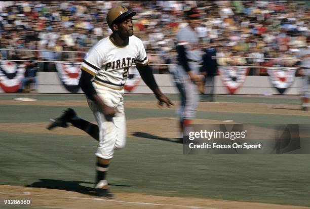 Outfielder Roberto Clemente of the Pittsburgh Pirates races down the first baseline against the Baltimore Orioles during the World Series October...