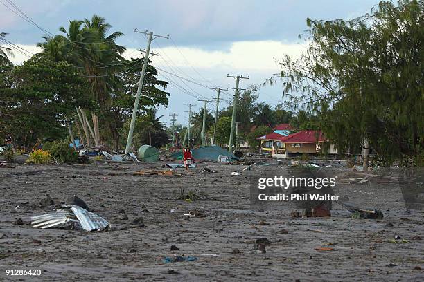 Young gril walks among the devastation following yesterday's 8.3 on the Richter scale strong earthquake which struck 200km from Samoa's capital Apia...