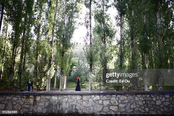 Turkish woman walks past the foliage near a mineral-rich stream full of 'doctor fish', on September 13, 2009 in Kangal, 105 kilometers south of the...