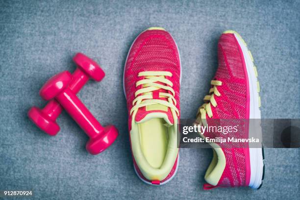 high angle view of dumbbell and sport shoes - pink sneakers fotografías e imágenes de stock