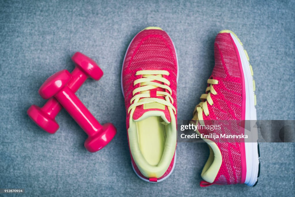 High Angle View Of Dumbbell and Sport Shoes