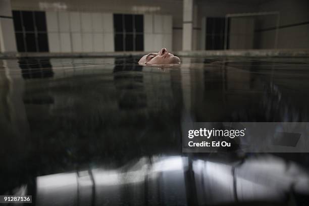 Polish psoriasis patient Michal Lisiak floats as 'doctor fish' eat away at his lesions as part of his treatment on September 13, 2009 in Kangal, 105...