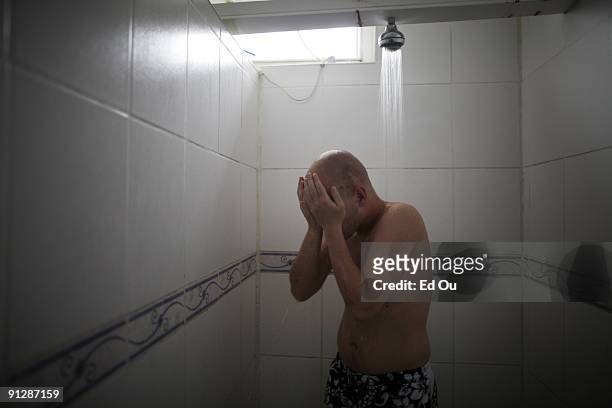 Polish psoriasis patient Michal Lisiak showers before entering a mineral-rich pool with 'doctor fish' as part of his treatment, on September 13, 2009...