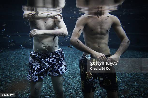Doctor fish' nibble away at lesions off of psoriasis patients Michal Lisiak, 26 from Poland, and a patient from Germany, as part of their treatment...