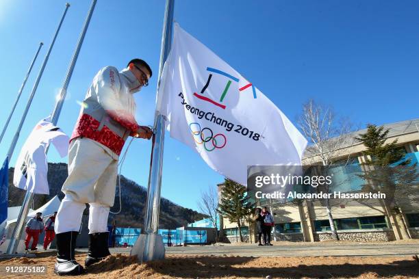 Volunter adjust the PyeongChang 2018 flag for the PyeongChang 2018 Olympic Village opening ceremony at the PyeongChang 2018 Olympic Village Plaza on...