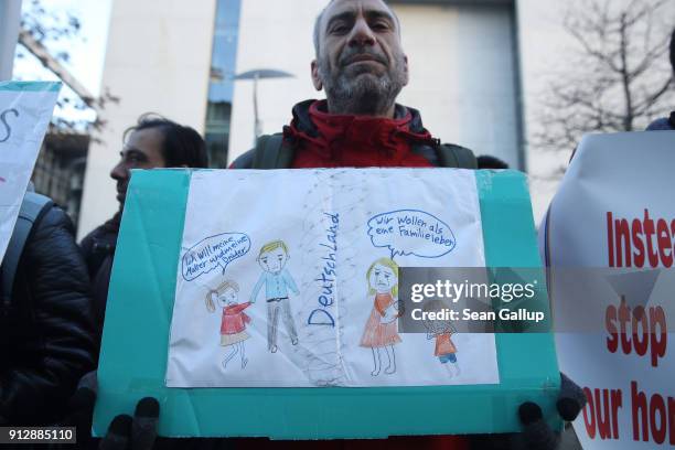 Refugees and migrants protest outside the Bundestag prior to debates and a vote over the rights of refugees who have been granted limited asylum in...