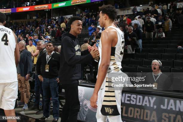 Atlanta Hawks player and former Wake Forest player John Collins greets with Wake Forest's Olivier Sarr after the game. The Wake Forest University...