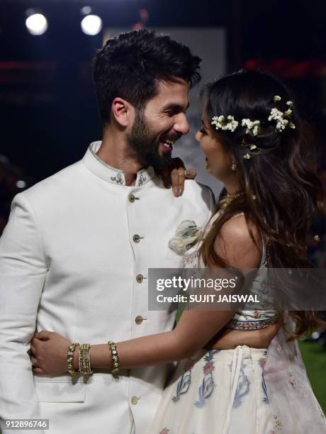 Indian Bollywood actor Shahid Kapoor with his wife Mira Rajput showcase a creation by designer Anita Dongre at the Lakmé Fashion Week Summer Resort...