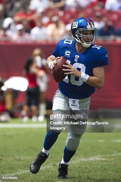 Quarterback Eli Manning of the New York Giants looks for a receiver during a NFL game against the Tampa Bay Buccaneers at Raymond James Stadium on...