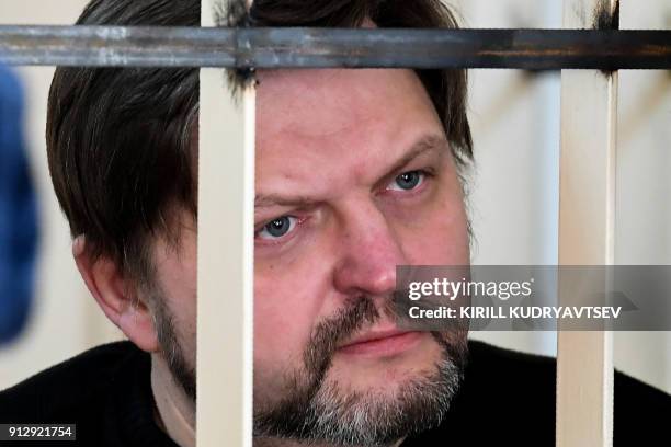 Nikita Belykh, ex-Kirov region governor, looks on as he stands inside defendants cage prior to a hearing at the Presnensky district court in Moscow...