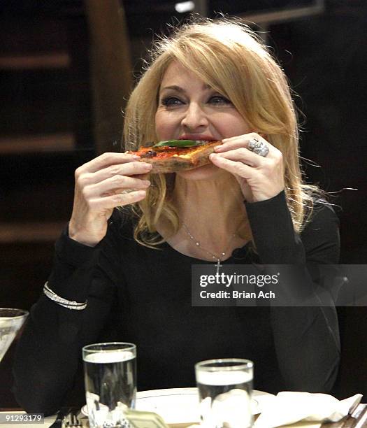 Madonna eats at Angelo's Pizza while she visits "Late Show with David Letterman" at the Ed Sullivan Theater on September 30, 2009 in New York City.