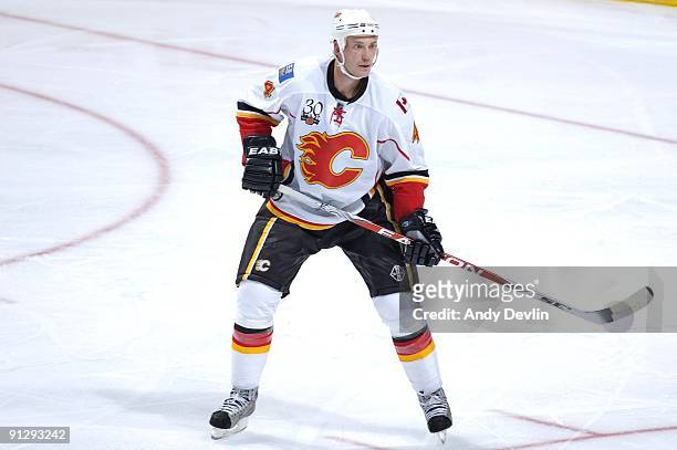 Jay Bouwmeester of the Calgary Flames concentrates on the puck during a pre-season game against the Edmonton Oilers at Rexall Place on September 23,...