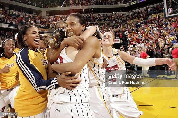 Tammy Sutton-Brown of the Indiana Fever hughs teammate Tully Bevilaqua as they celebrate winning the Eastern Conference Championship after defeating...