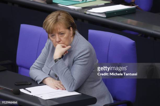 Germany Chancellor Angela Merkel sits in the Plenary Hall of the Parliament or Bundestag during the debate on Refugee rights to Family conjunction on...