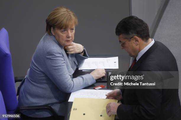 Germany Chancellor Angela Merkel chat with Foreign minicter Sigmar Gabriel in the Plenary Hall of the Parliament or Bundestag during the debate on...