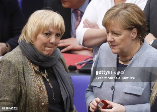 Green party member Claudia Roth chats with Germany Chancellor Angela Merkel in the Plenary Hall of the Parliament or Bundestag during the debate on...