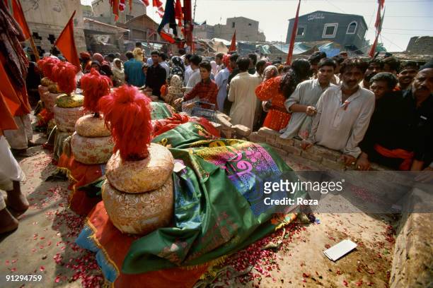 Group of of pilgrims visiting tombs of important disciples of Bodla Bahar who are buried inside his shrine's yard, September, 2006 in Sehwan Sharif,...
