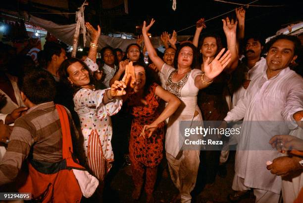 Group of Hijras in pilgrimage in Sehwan sharif, perfroming Dhmal during the annual celebrations of Urs of Lal shahbaz Qalandar, a 13th century Sufi...