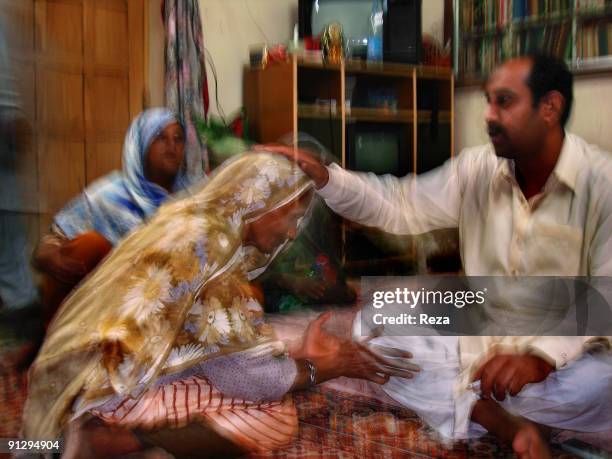 Woman visiting the sufi master , Sheikh Akhtar Hussein Pirzada, titled as Noor Ali Shah. It is a privilage for the pilgrims to visit him, for some to...